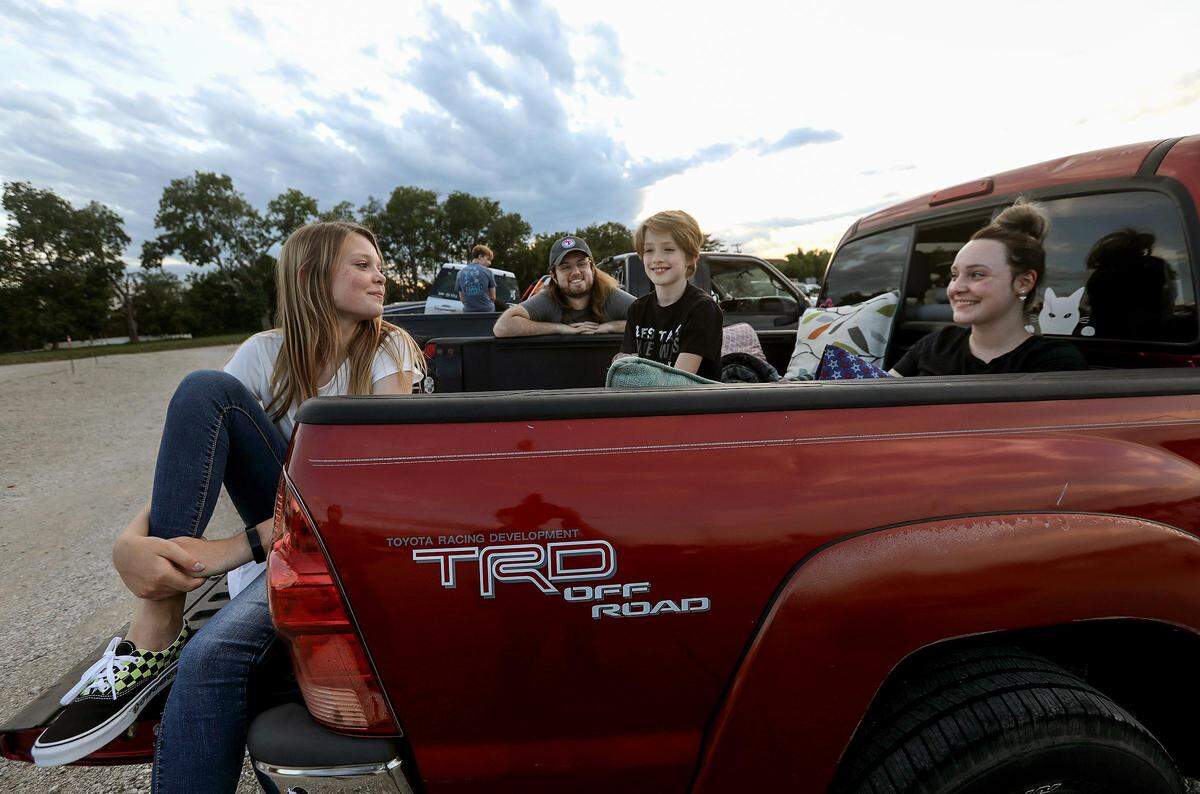 Madison Grindstaff and her brother Ethan get comfortable in the back of their aunt and uncle’s pickup truck to watch “Harry Potter and the Chamber of Secrets” at Coyote Drive-In movie theater on Wednesday, May 27, 2020, in Fort Worth. Ryan and Crystal Kirby said except for grocery shopping they have stayed at home with their niece and nephew, but thought the drive-in offered a good setup to leave the house but to also social distance. From left, Madison Grindstaff, 13, Ryan Kirby, Ethan Grindstaff, 9, and Crystal Kirby.