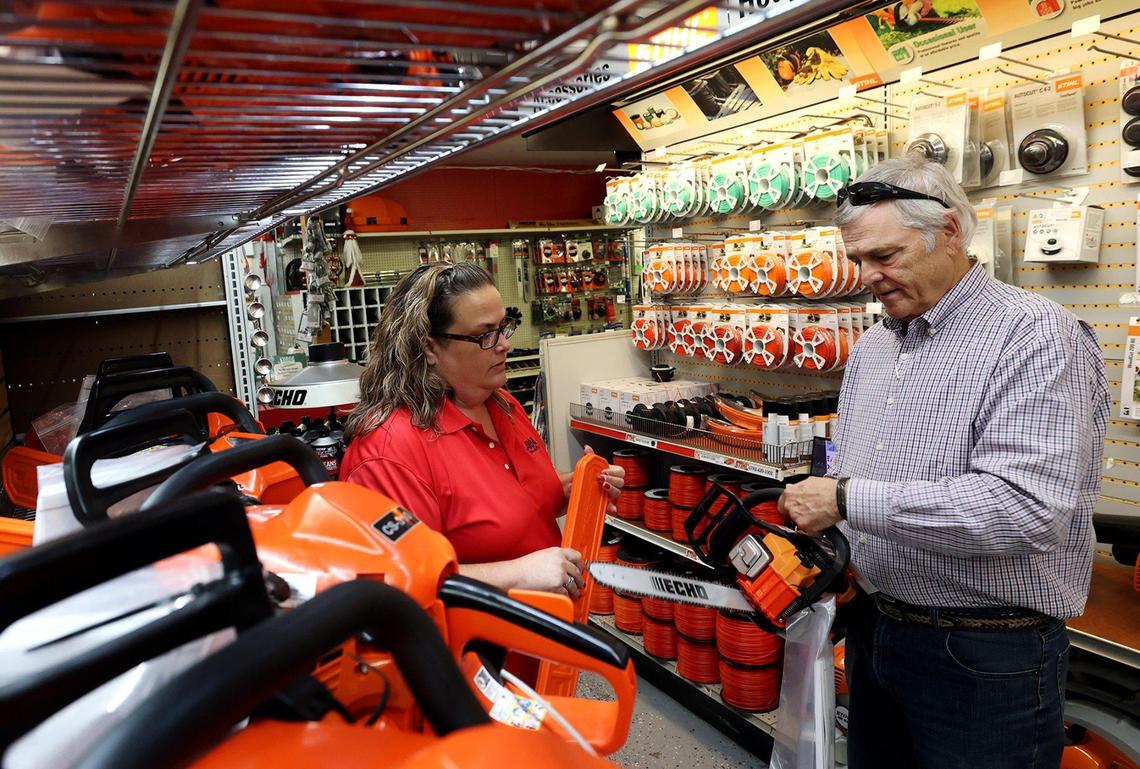 Lawn and Garden Warehouse and Hardware employee Kimberly Ohde, left, helps Donny Terrell select a chainsaw on Wednesday, December 13, 2023, in Fort Worth.