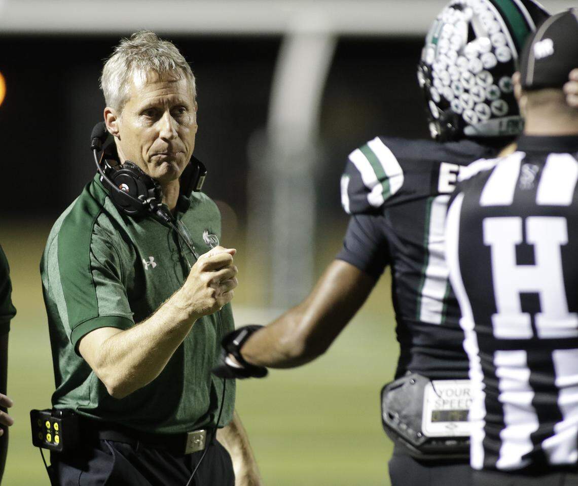 Mansfield Lake Ridge head coach Kirk Thor congratulates players after a touchdown against Euless Trinity during their Class 6A Division I bi-district game on Friday, November 14, 2025 at Newsom Stadium in Mansfield Texas.
