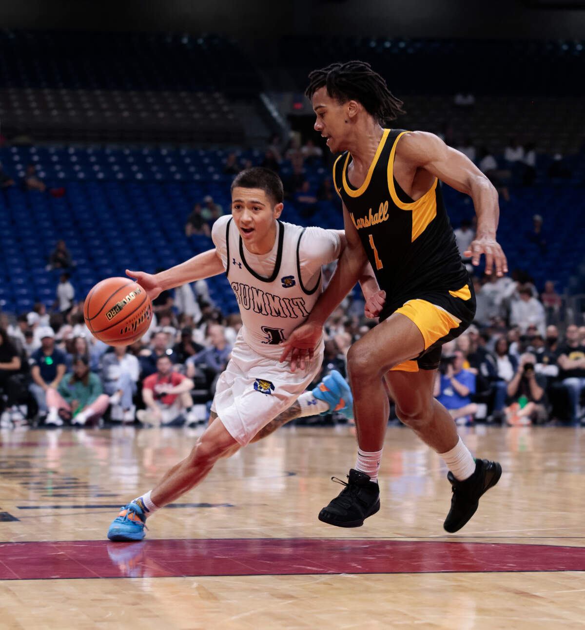 Mansfield Summit’s Theo Brannan (1 in white) drives around Missouri City Marshall’s Armani Theus (1 in black) in the Class 5A Division 2 state championship game on Saturday, March 8, 2025 at the Alamodome in San Antonio, Texas. Summit defeated Marshall 54-47.