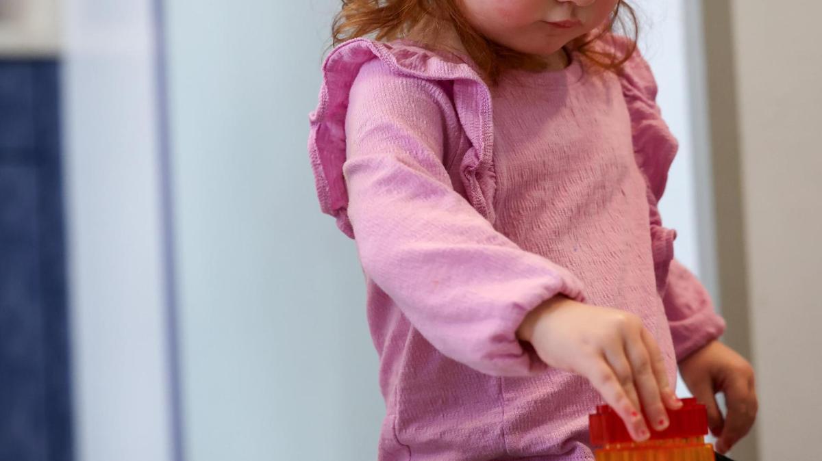 Meryle, 2, plays with blocks while being cared for at Kids’ Place Child Development Center on Jan. 15 in Fort Worth.
