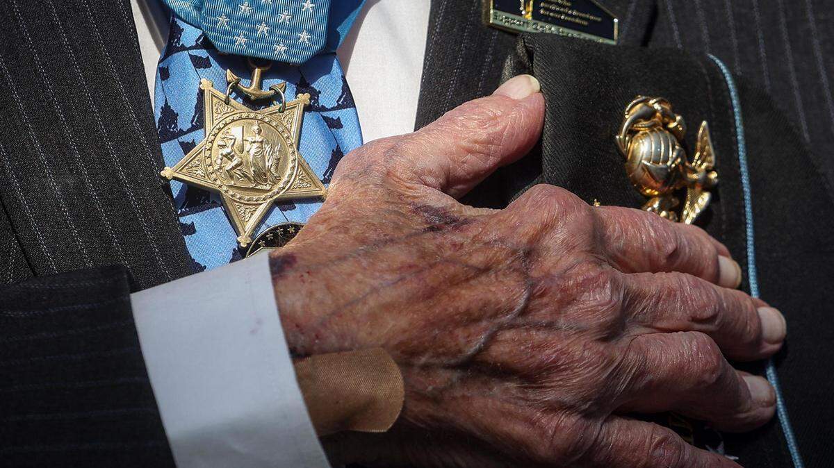 World War II veteran and recipient of the Medal of Honor Hershel Woodrow Williams puts his hand over his heart during the invocation at the National Medal of Honor Museum groundbreaking ceremony in Arlington on Friday, March 25, 2022.