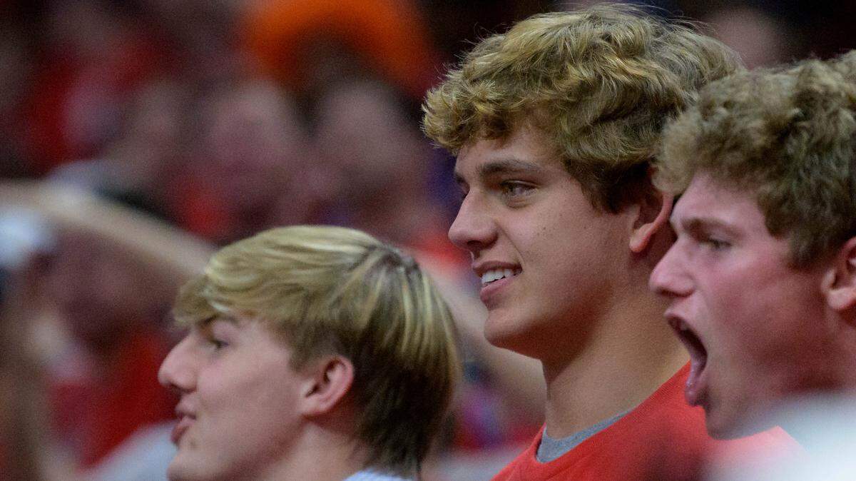 Arch Manning, center, the grandson of NFL quarterback Archie Manning and nephew of Eli and Peyton Manning; watches Game 4 of an NBA basketball first-round playoff series between the New Orleans Pelicans and the Phoenix Suns in New Orleans in April. The high school quarterback committed to Texas on Thursday.