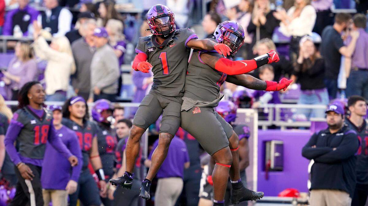 TCU cornerback Tre’Vius Hodges-Tomlinson (1) and defensive tackle Kenny Turnier, right, celebrate after Hodges-Tomlinson broke up a Baylor pass that was then intercepted by teammate cornerback Kee’Yon Stewart in the Horned Frogs upset of Baylor in 2021.