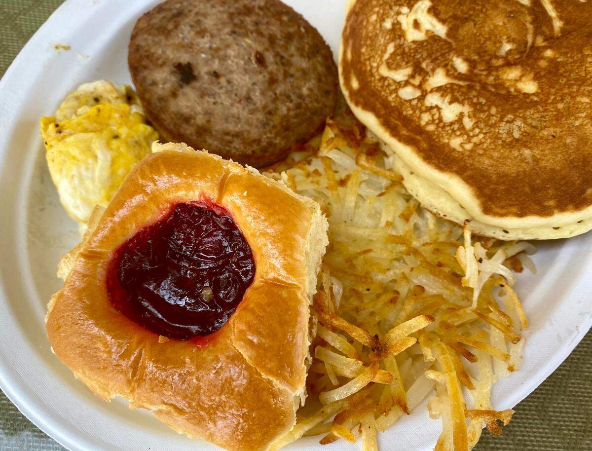 A cherry kolache with pancakes, eggs, hash browns and sausage at Pearl Snap Kolaches.