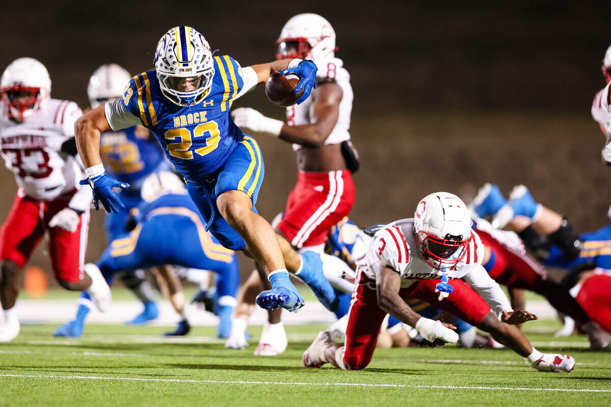 Brock running back Jack Farhat leaps past a diving Carthage defender in a Class 4A Division II state semifinal Friday at Memorial Stadium in Mesquite.