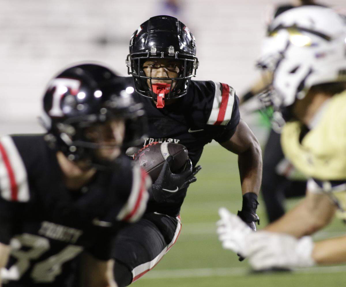 Euless Trinity running back Jayden Hollins follows his blocking against Keller during their game on Friday, October 17, 2025 at Pennington Field in Bedford, Texas.