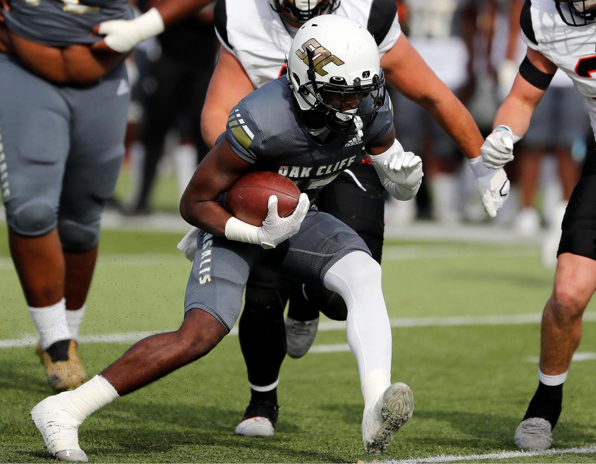 South Oak Cliff running back Ke’Undra Hollywood (12) gains yards up the middle during a high school Class 5A Division 2 Regional football game at Newsom Stadium in Mansfield, Texas, Friday Nov. 26, 2021. South Oak Cliff led 27-14 at the half. (Special to the Star-Telegram Bob Booth)