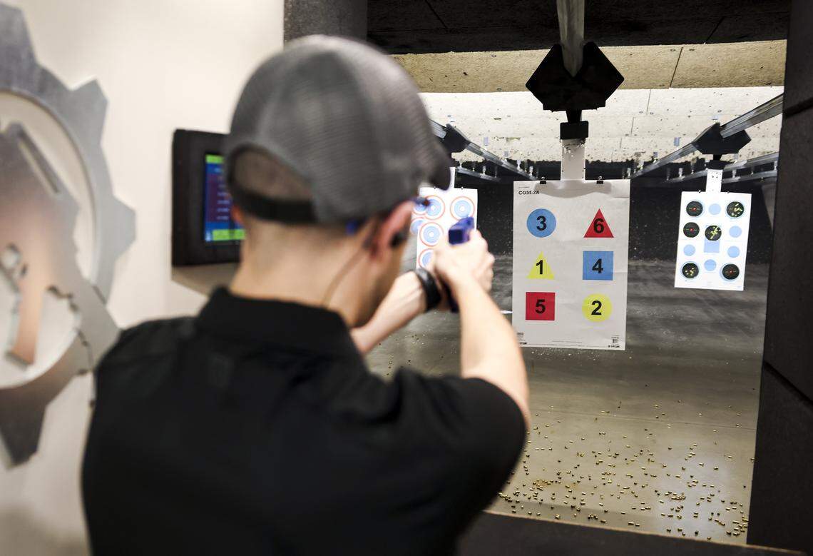 Ike Hajinazarian demonstrates the correct stance when shooting a gun on Tuesday, April 21, 2026 in The Colony, Texas. Hajinazarian owns Liberty for All Training Co., an inclusive firearm training company that offers shooting lessons and firearm safety courses.