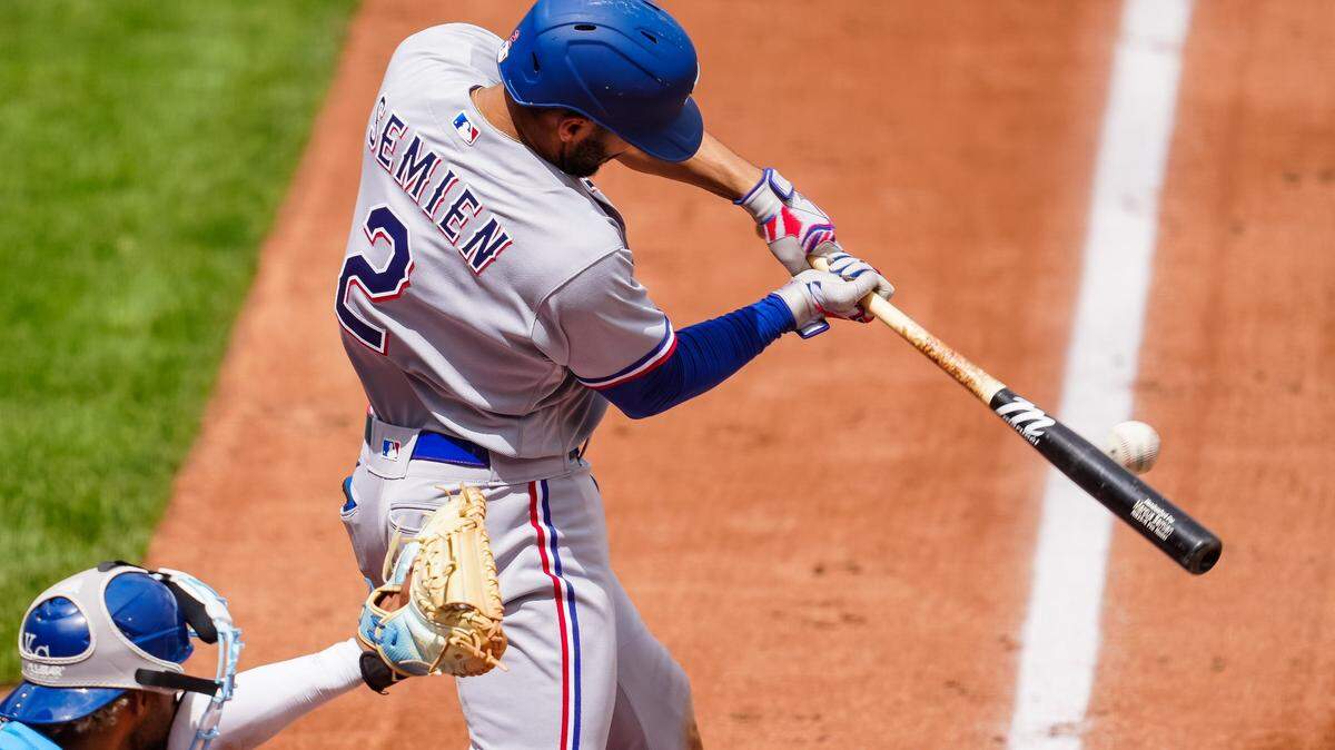 Texas Rangers second baseman Marcus Semien (2) hits an RBI single during the fourth inning of the Rangers series finale win against the Kansas City Royals at Kauffman Stadium.