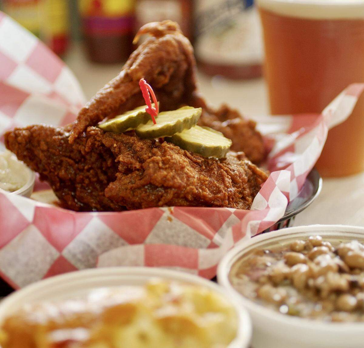 A “Nashville hot" chicken breast and wing with sides of pimento mac-and-cheese, cole slaw and a black-eyed pea salad are ready to be enjoyed at Hattie B’s Hot Chicken on 19th Avenue South in Nashville, Tennessee, on Sept. 18, 2012.