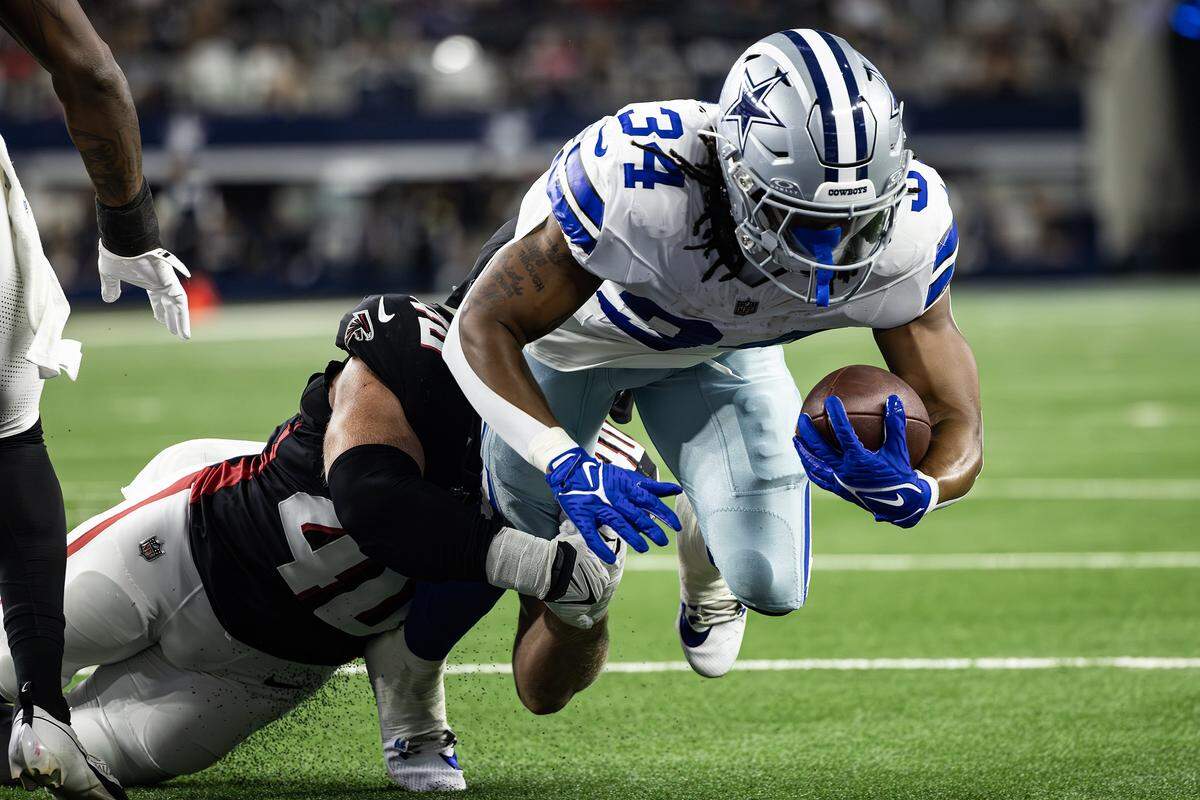 Cowboys running back Jaydon Blue (34) dives into the end zone for a touchdown in the first half of an NFL preseason game between the Dallas Cowboys and the Atlanta Falcons at AT&T Stadium in Arlington on Friday, Aug. 22, 2025,