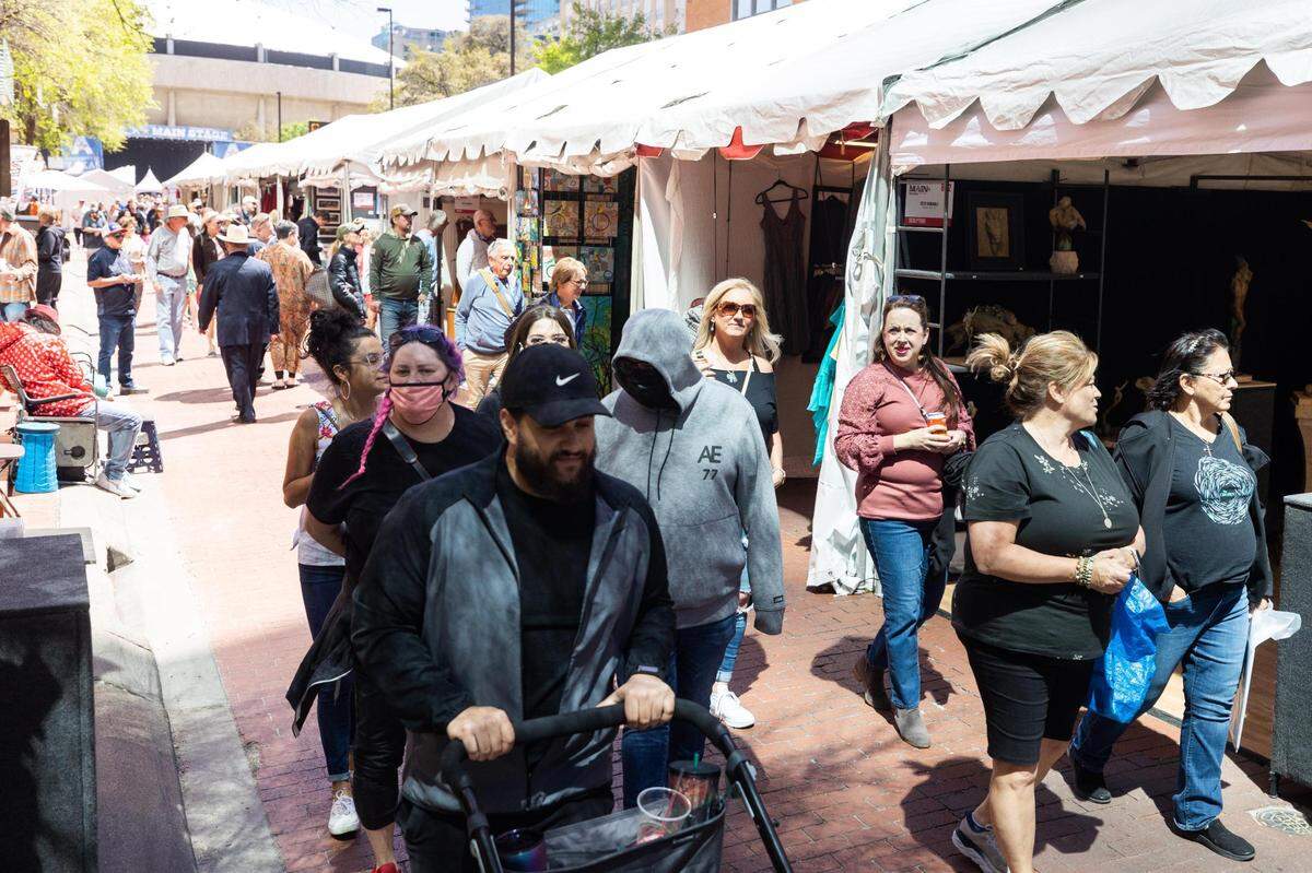 Festival goers walk past booths during the Main Street Fort Worth Arts Festival Thursday, April 7, 2022, in downtown Fort Worth.