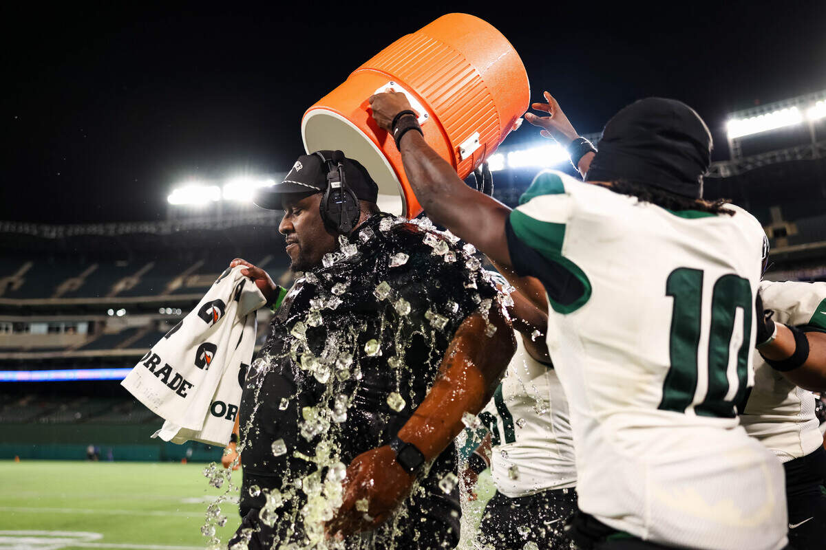 Berkner players dump Gatorade on head coach Trey Bryant on the sideline after a 30-28 win over Arlington Bowie in a bi-district playoff game at Choctaw Stadium in Arlington, Texas, on Nov. 14, 2025.