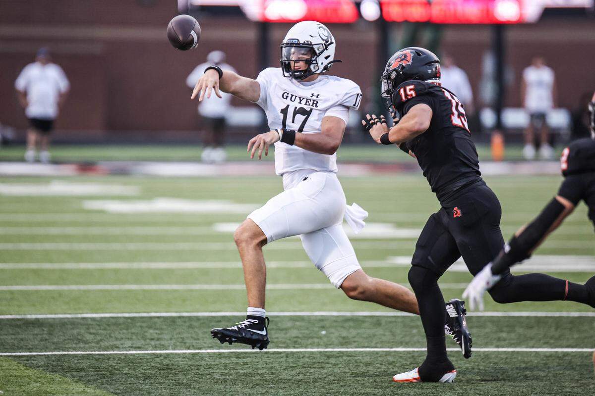 Denton Guyer quarterback Zephyr Kreye is pressured by Aledo’s Kutter Harrell in a football game at Tim Buchanan Stadium in Aledo, Texas, on Friday, Aug. 29, 2025.