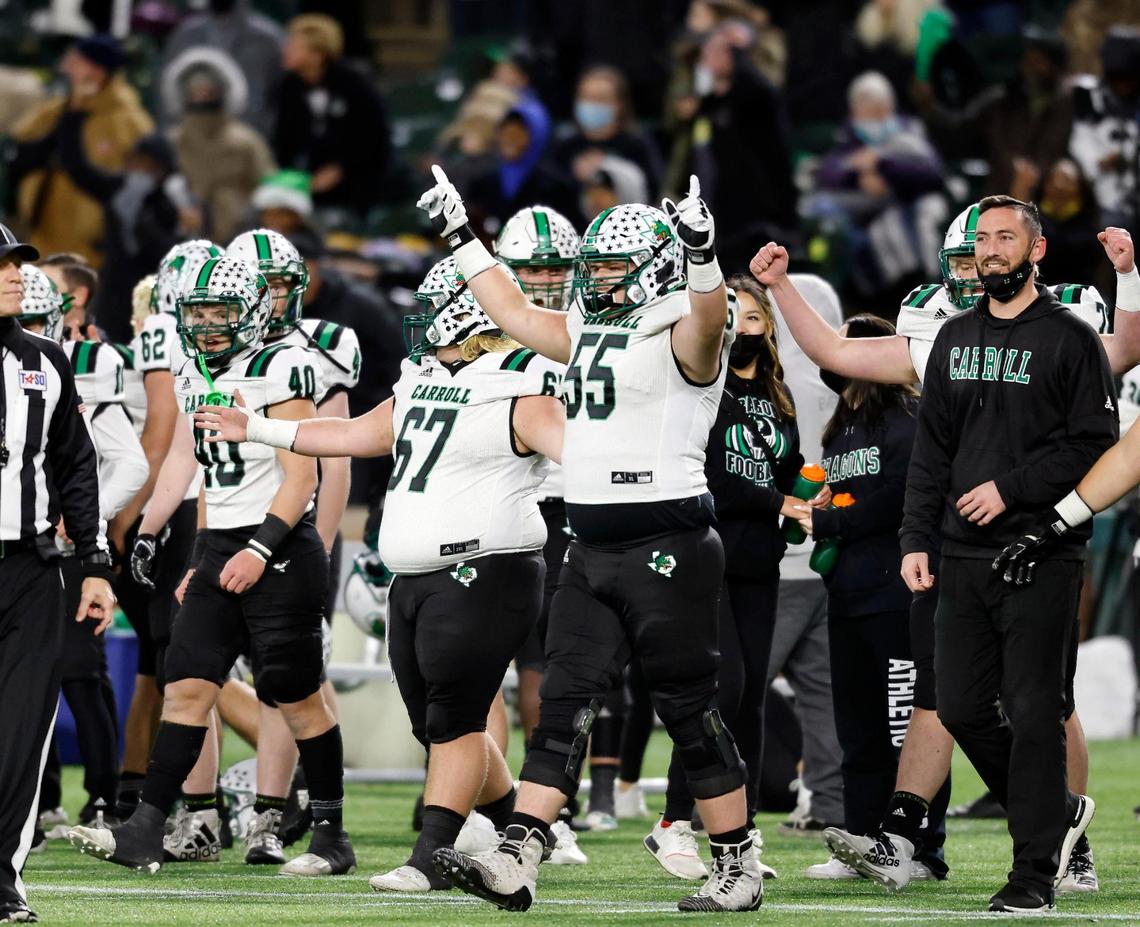 Southlake Carroll’s Kaleb Loveless (55) and the team walk onto the field signaling a win at the end of a Conference 6A Division 1 regional playoff football game at Globe Life Park in Arlington, Texas, Friday, Dec. 24, 2020. Southlake Carroll defeated Arlington Martin 30-26. (Special to the Star-Telegram Bob Booth)