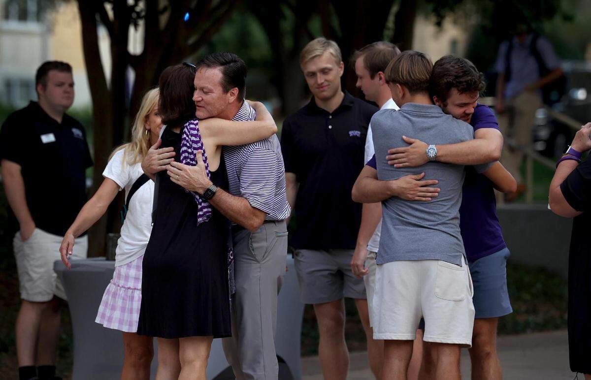 Philip Smith, left, the father of Wes Smith, and other family members hug attendees for a vigil for Wes Smith on TCU’s campus on Wednesday, September 6, 2023, in Fort Worth. Wes Smith was shot and killed in an apparently random act of violence in Fort Worth on Friday.