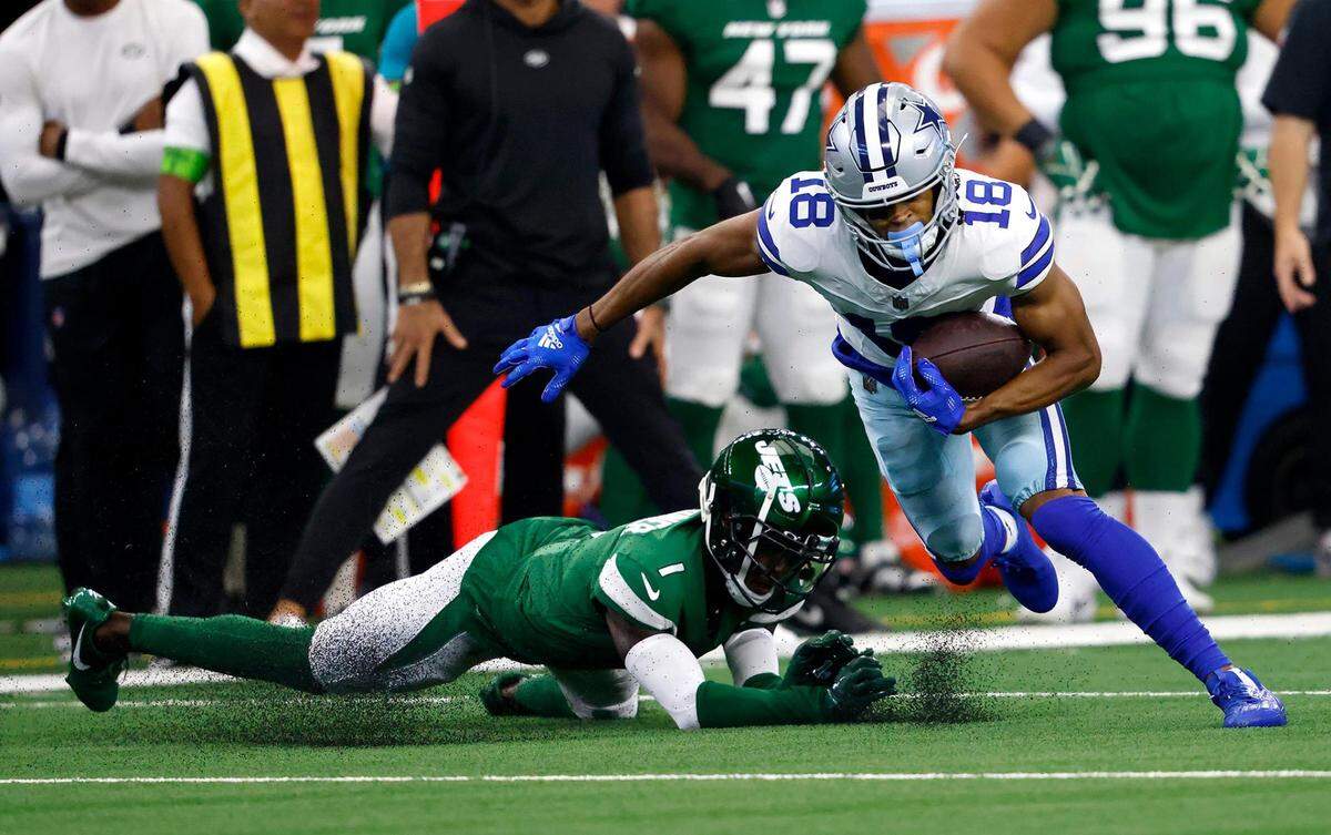 Dallas Cowboys wide receiver Jalen Tolbert runs past New York Jets cornerback Sauce Gardner on Sunday, September 17, 2023, at AT&T Stadium in Arlington.