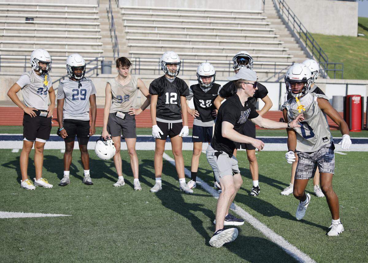 Defensive backs coach Easton Pheler coaches senior cornerback Donovan Hollis during the first practice of 2025 for the All Saints in Fort Worth, Texas, Tuesday August, 05, 2025.