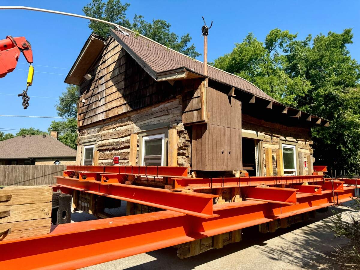 Crews on Friday moved the Bushong Log Cabin from a site near the Gaylord Texan to Liberty Plaza on Main Street, where the historic structure will be restored.