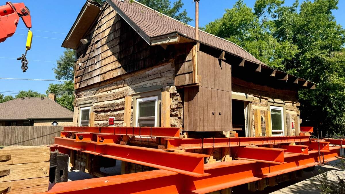 Crews on Friday moved the Bushong Log Cabin from a site near the Gaylord Texan to Liberty Plaza on Main Street, where the historic structure will be restored.