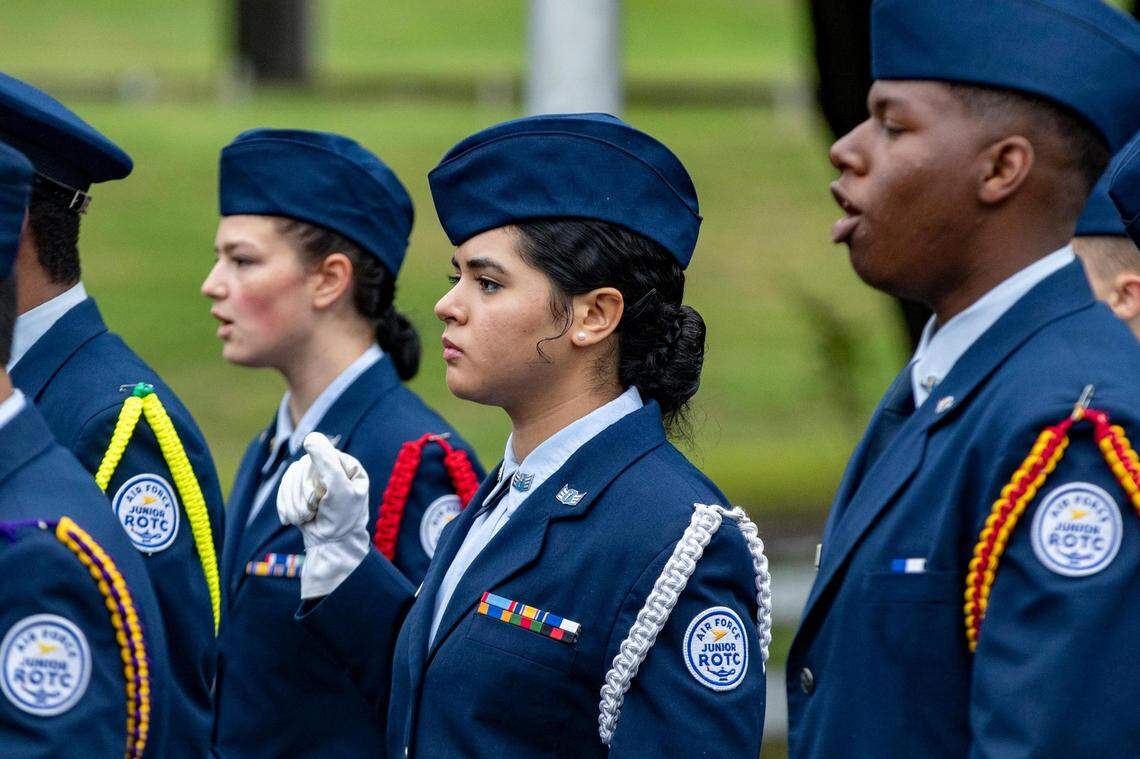 An Air Force Junior ROTC cadet remains steady despite rain during the Veterans Day Parade in Fort Worth on Friday, Nov. 11, 2022. Hundreds of participants marched down North Forest Park Boulevard, waving American flags and signing a medley of military songs.
