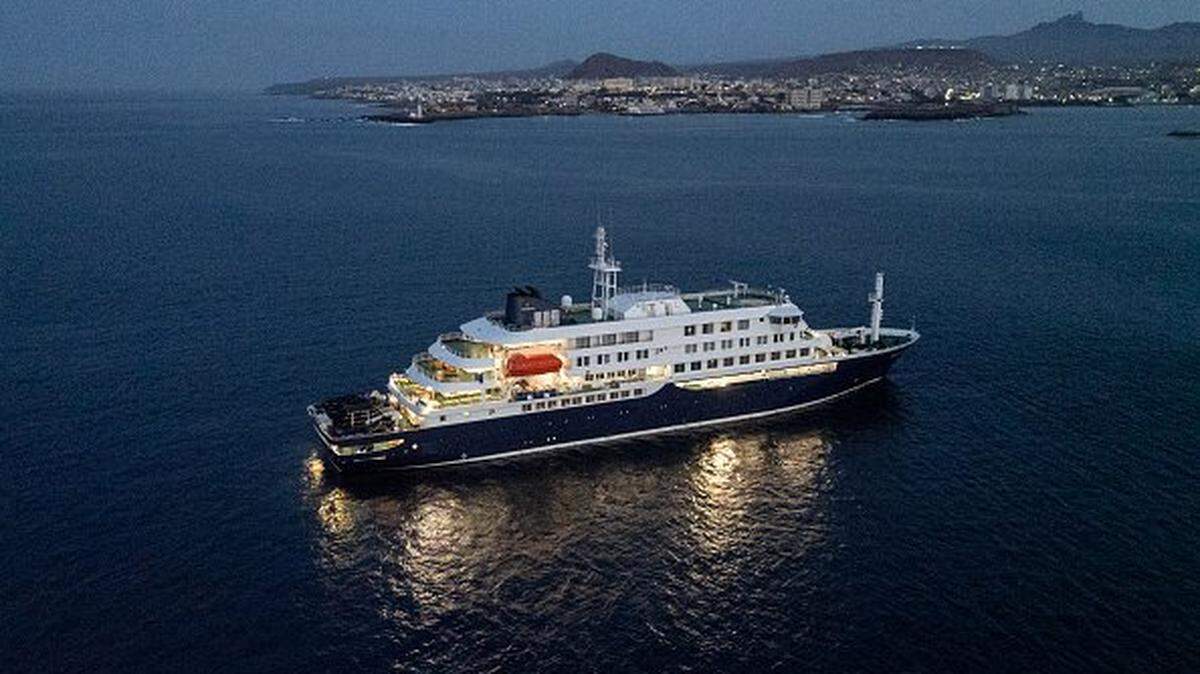 A general view of the cruise ship MV Hondius, while stationary off the port of Praia, the capital of Cape Verde, on May 6, 2026. Two seriously ill crew members on a cruise ship stricken by a deadly hantavirus outbreak will be evacuated via Cape Verde to the Netherlands, allowing the vessel to sail on to Spain's Canary Islands, the ship operator said on May 5, 2026. The MV Hondius has been at the centre of an international health scare since Saturday, when WHO was informed that the rare disease -- usually spread from infected rodents typically through urine, droppings and saliva -- was suspected of being behind the deaths of three of its passengers. As others fell ill, passengers and crew have been in isolation after Cape Verde authorities barred the ship from docking, and as health authorities scrambled to find a port that would take the Hondius. (Photo by AFP via Getty Images)