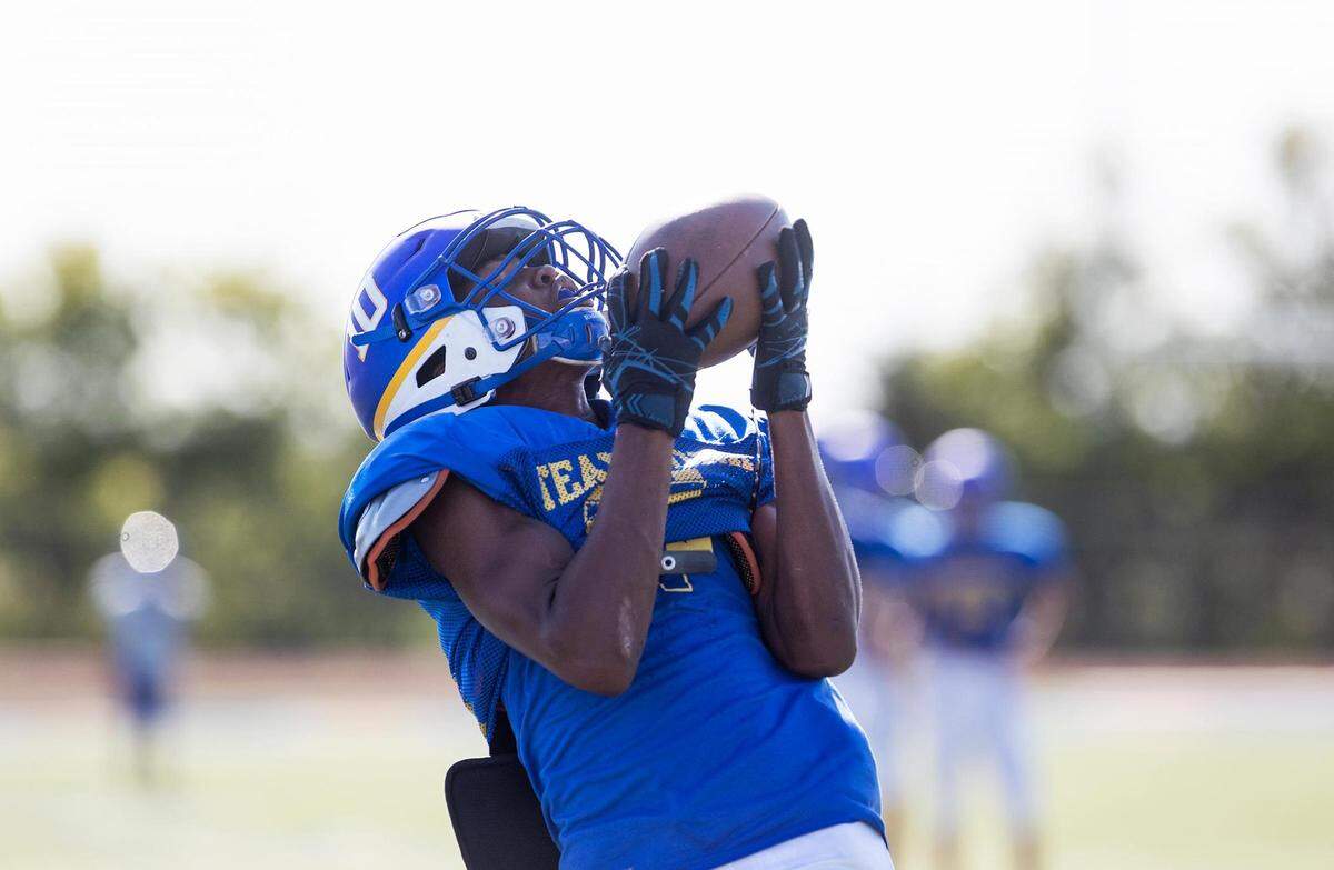 Venus High wide receiver Chris Webster makes a catch during practice.