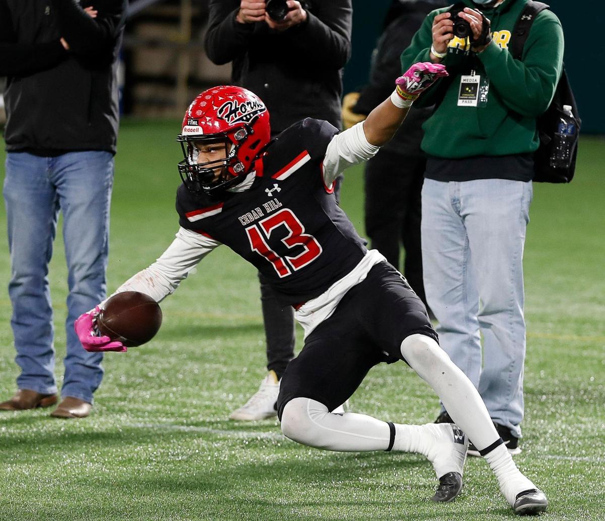 Cedar Hill wide receiver Javien Clemmer (13) rolls out of the end zone after catching the winning touchdown pass during the 6A division 2 quarterfinals at Globe Life Park in Arlington, Texas, Saturday, Jan. 02, 2021. With the game tied in regulation Cedar Hill won 27-24 in overtime. (Special to the Star-Telegram Bob Booth)