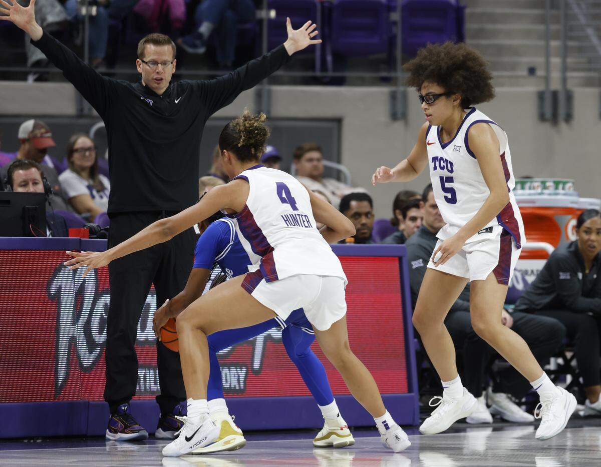 TCU guards Donovyn Hunter (4) and Olivia Miles (5) box in Tennessee State guard Amiyah Ferguson (55) in front of the Frog bench during the second quarter of a NCAA women's basketball game between Tennessee State and TCU at Schollmaier Arena in Fort Worth, Texas, Wednesday Nov. 12, 2025.