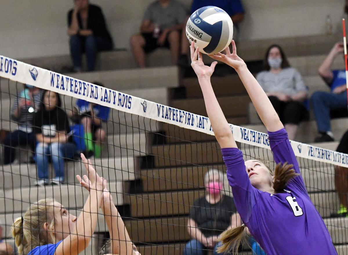 Paschal’s Emory Hinckley, right, puts the ball over the net as Weatherford’s Kate Hansen prepares to defend in game one of their volleyball match Tuesday, October 13, 2020 at the ninth grade center in Weatherford, Texas. Weatherford won the match 25-7, 25-8 and 25-21. Special/Bob Haynes