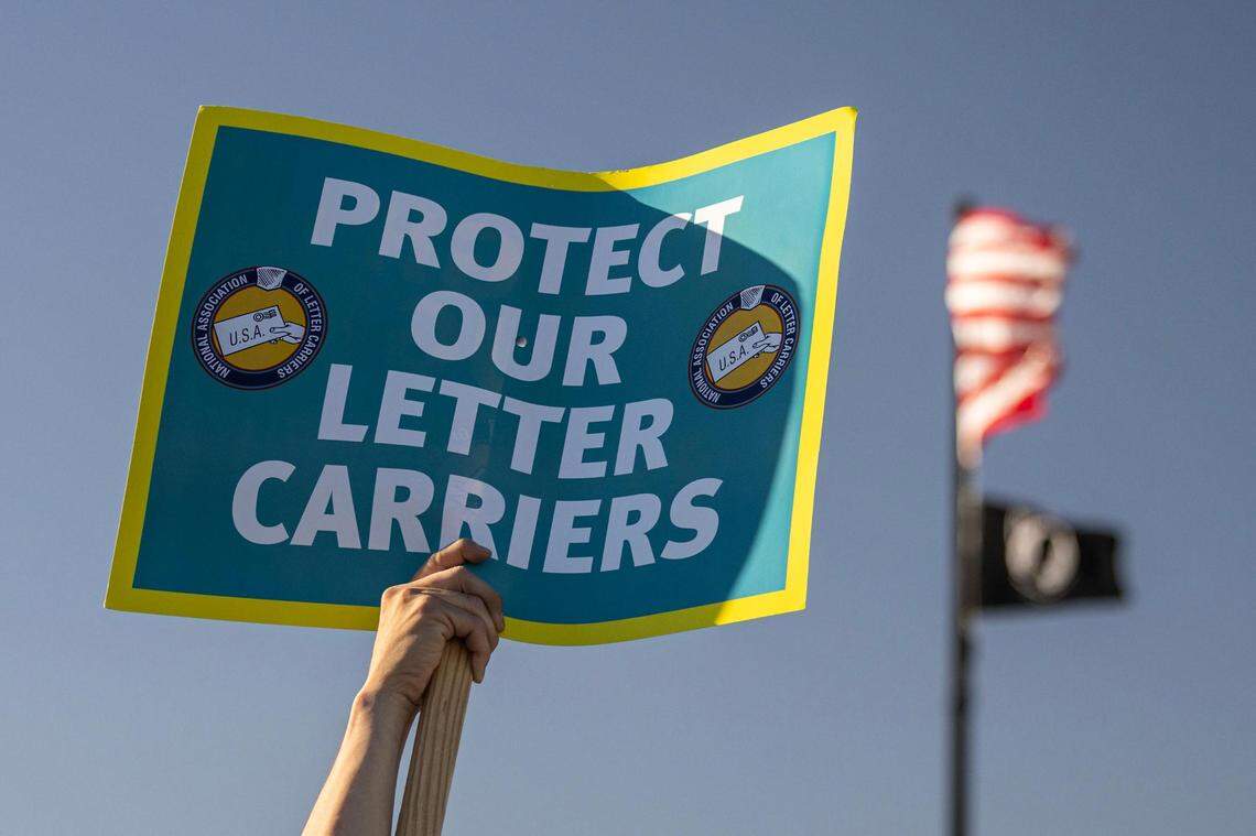 Members of the National Association of Letter Carriers gather to express their frustrations due to a rise in assaults and robberies against mail carriers in Dallas and Fort Worth during a union rally at the United States Postal Service office in Dallas on Thursday, Feb. 22, 2024.