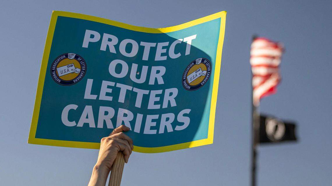 Members of the National Association of Letter Carriers gather to express their frustrations due to a rise in assaults and robberies against mail carriers in Dallas and Fort Worth during a union rally at the United States Postal Service office in Dallas on Feb. 22, 2024.