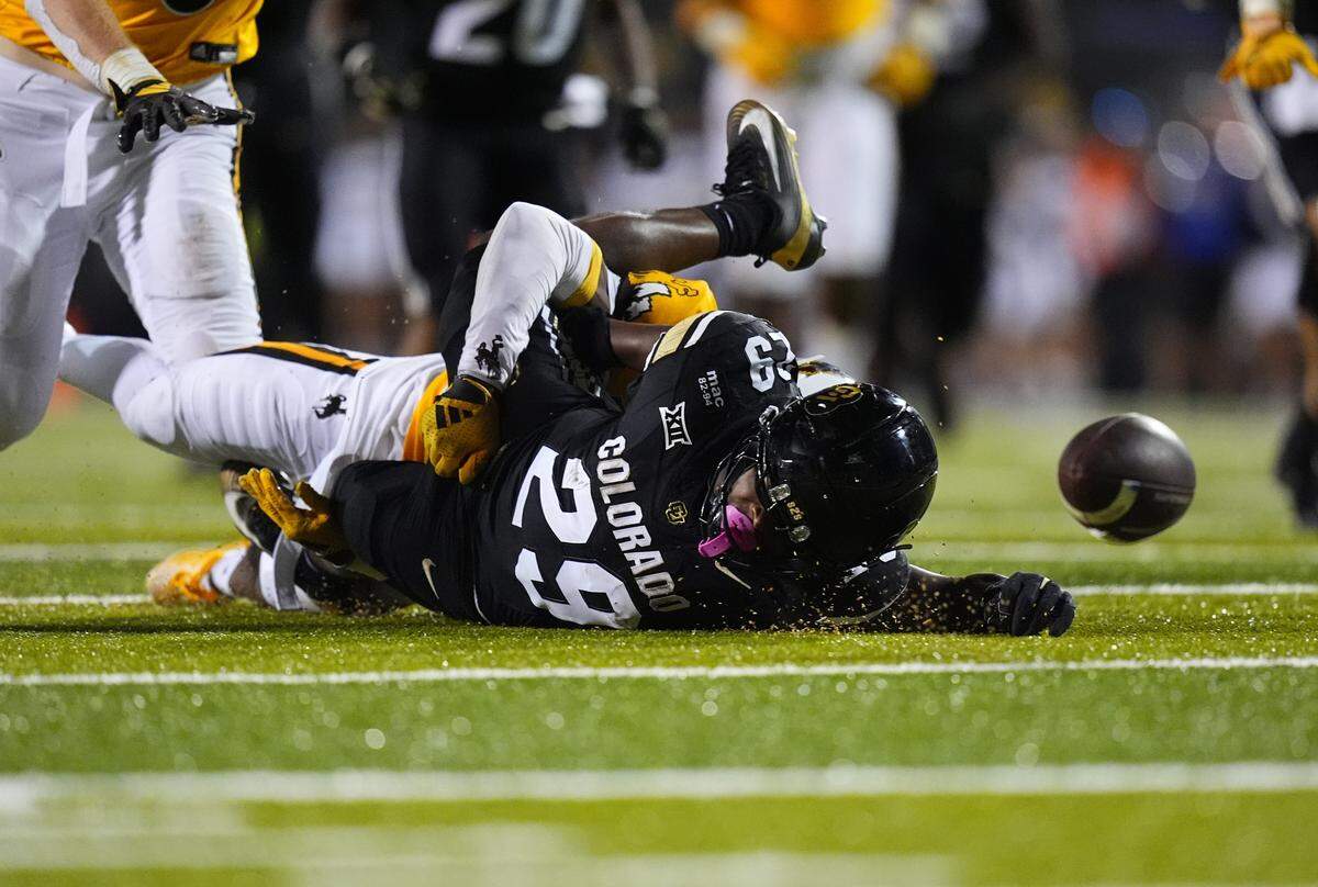 Sep 20, 2025; Boulder, Colorado, USA; Colorado Buffaloes running back Micah Welch (29) fumbles the football in the third quarter against the Wyoming Cowboys at Folsom Field. Mandatory Credit: Ron Chenoy-Imagn Images