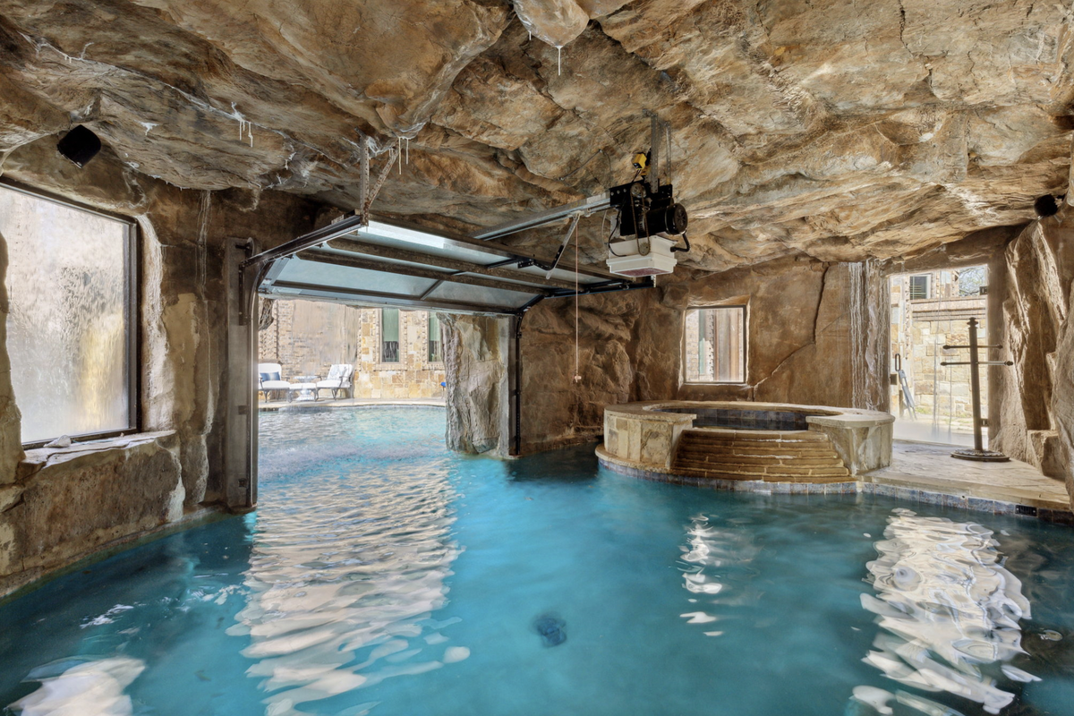 The 1.58-acre grounds include a pool with a swim-through grotto. (Provided by Briggs Freeman Sotheby’s International Realty)