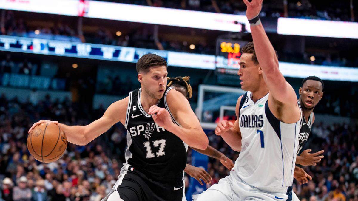 San Antonio Spurs forward Doug McDermott (17) attempts to dribble past Dallas Mavericks center Dwight Powell (7) in the first half of an NBA basketball game Thursday, Feb. 23, 2023, in Dallas. (AP Photo/Emil T. Lippe)