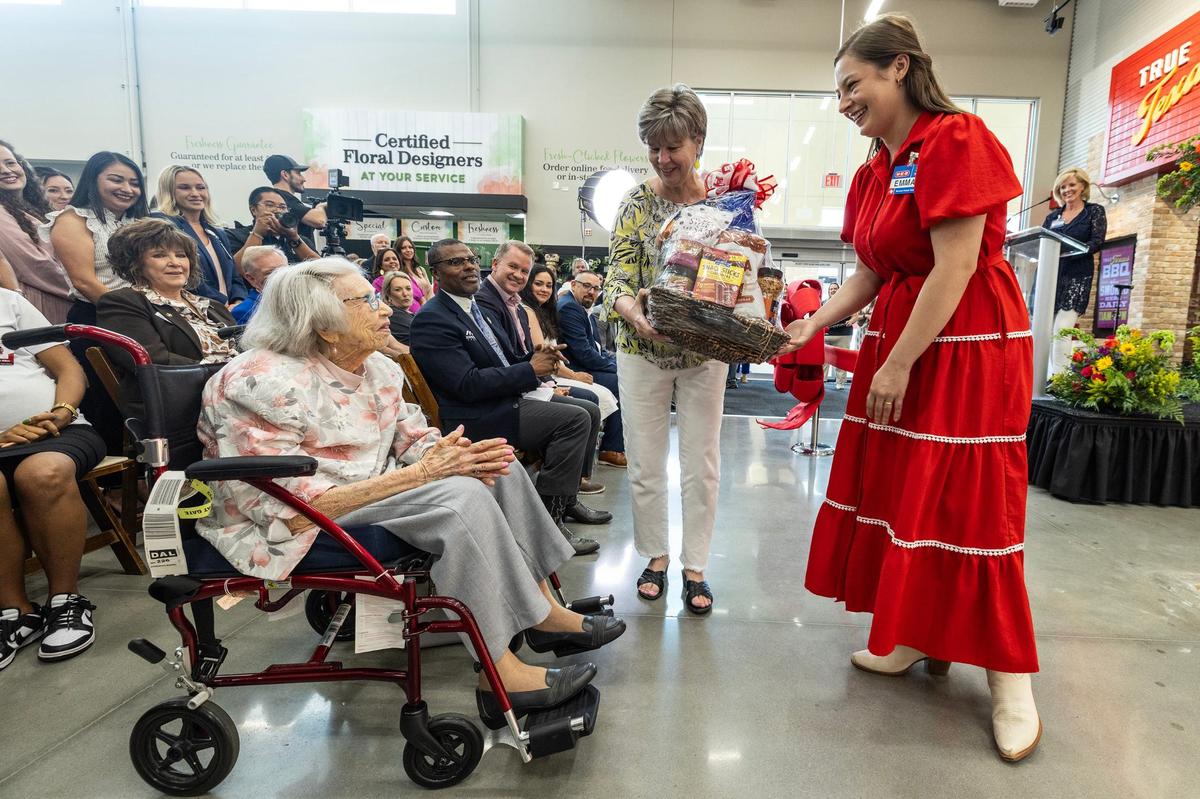 Margie Johnson, 97, receives a gift basket on behalf of HEB for being one of HEB’s biggest fans during the ribbon cutting ceremony for the new HEB location in Mansfield on Tuesday, June 25, 2024.