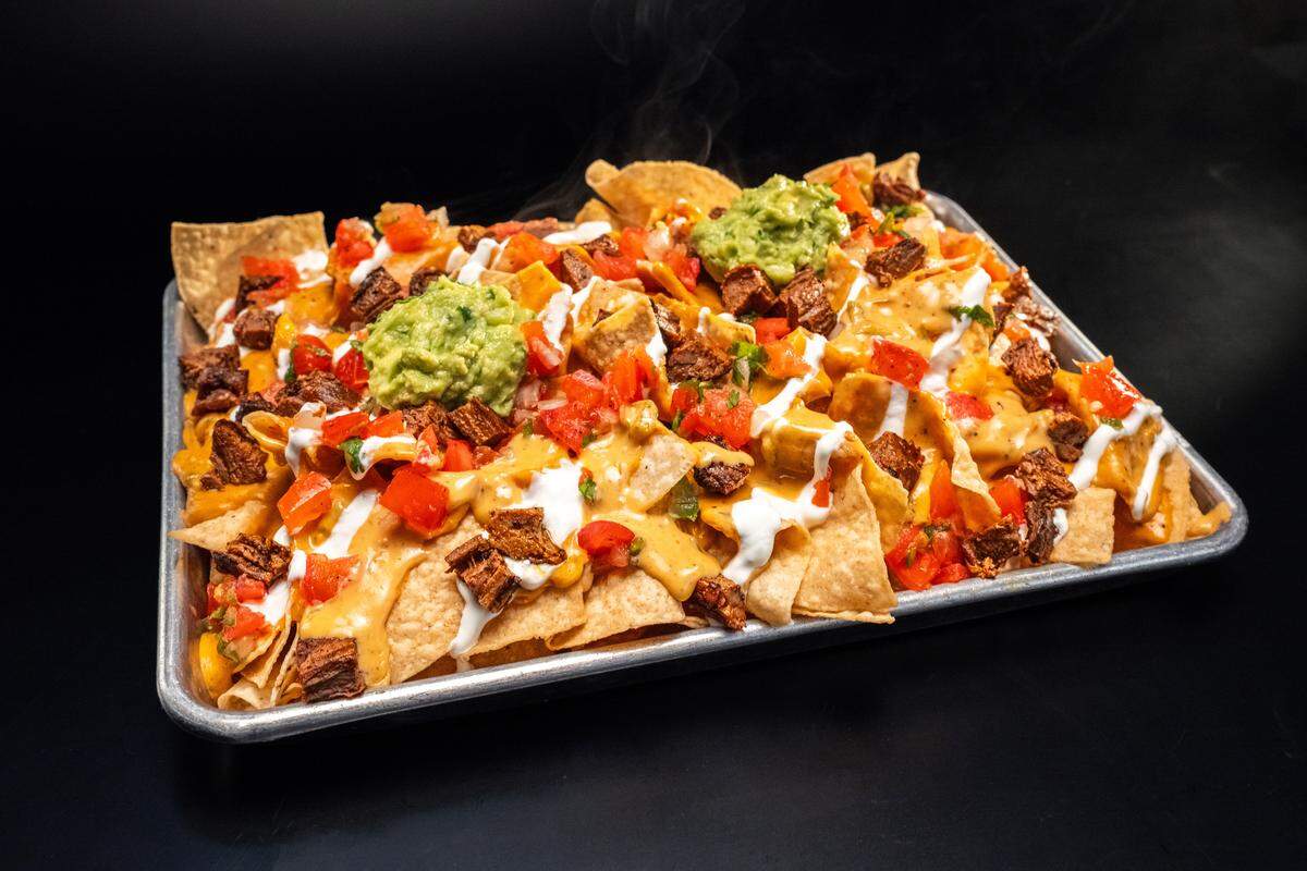 Torchy’s Tacos new menu item is nachos, topped with their award winning green chile queso.
