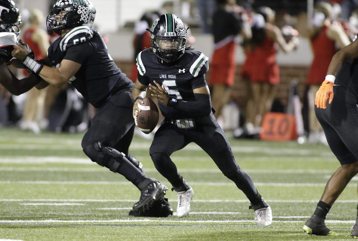 Mansfield Lake Ridge quarterback Deshawn Edwards (5) scrambles against Euless Trinity during their Class 6A Division I bi-district game on Friday, November 14, 2025 at Newsom Stadium in Mansfield Texas.