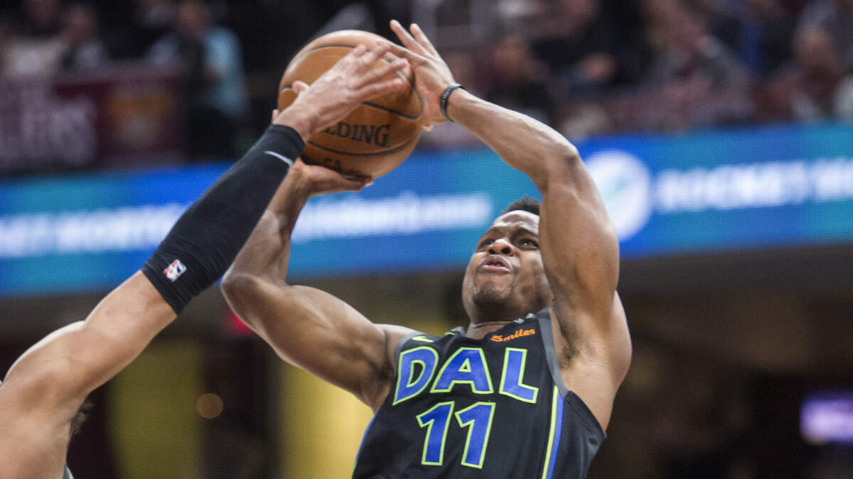 Dallas Mavericks' guard Yogi Ferrell shoots over the Cavaliers' Jordan Clarkson during a game in April. Ferrell was extended a qualifying offer by the club and will be a free agent on July 1.