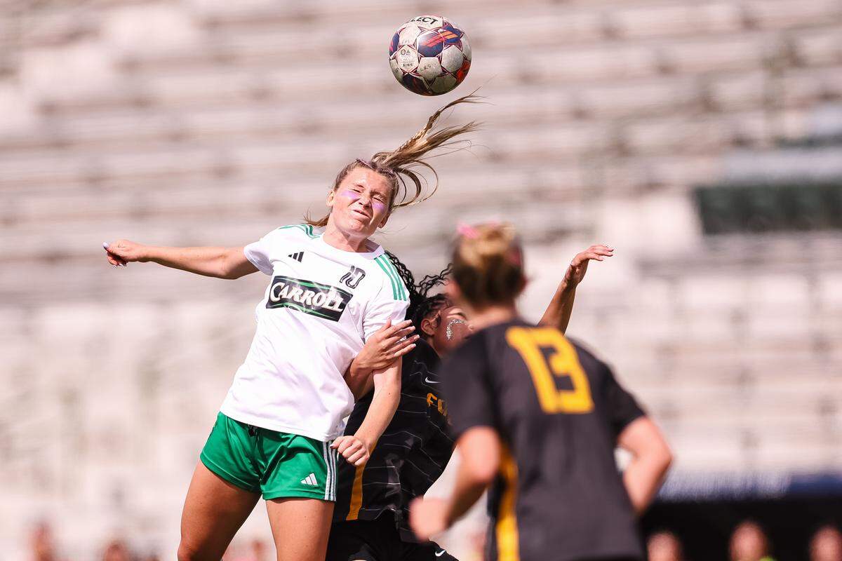Southlake Carroll midfielder Brady Burtnett (10) attempts to head the ball as a Forney defender attempts to pull her down in a UIL Class 6A Division 2 girls soccer state semifinal on Saturday, April 4, 2026, at Memorial Stadium in Mesquite, Texas.