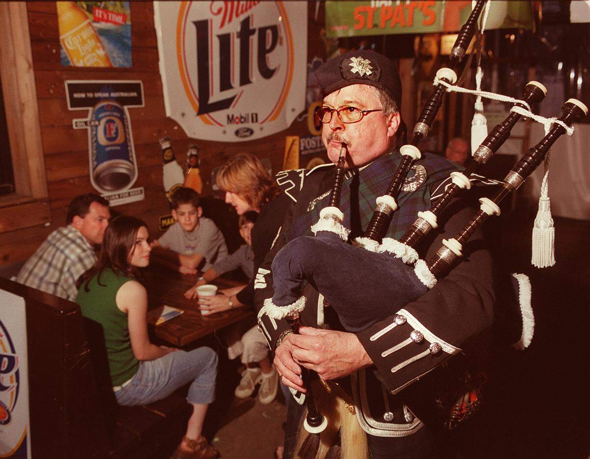 March 17, 2003: Don McCloud plays the bagpipes at the J. Gilligan’s St. Patrick’s Day festivities in Arlington.