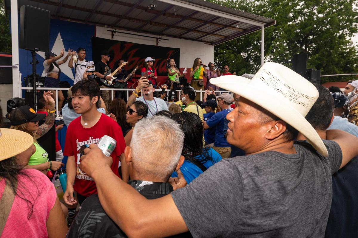 Festival attendees dance and party at the main live music stage on the third day of the Lao New Year festival at Wat Lao Thepnimith Temple in Saginaw on Sunday, April 27, 2025.