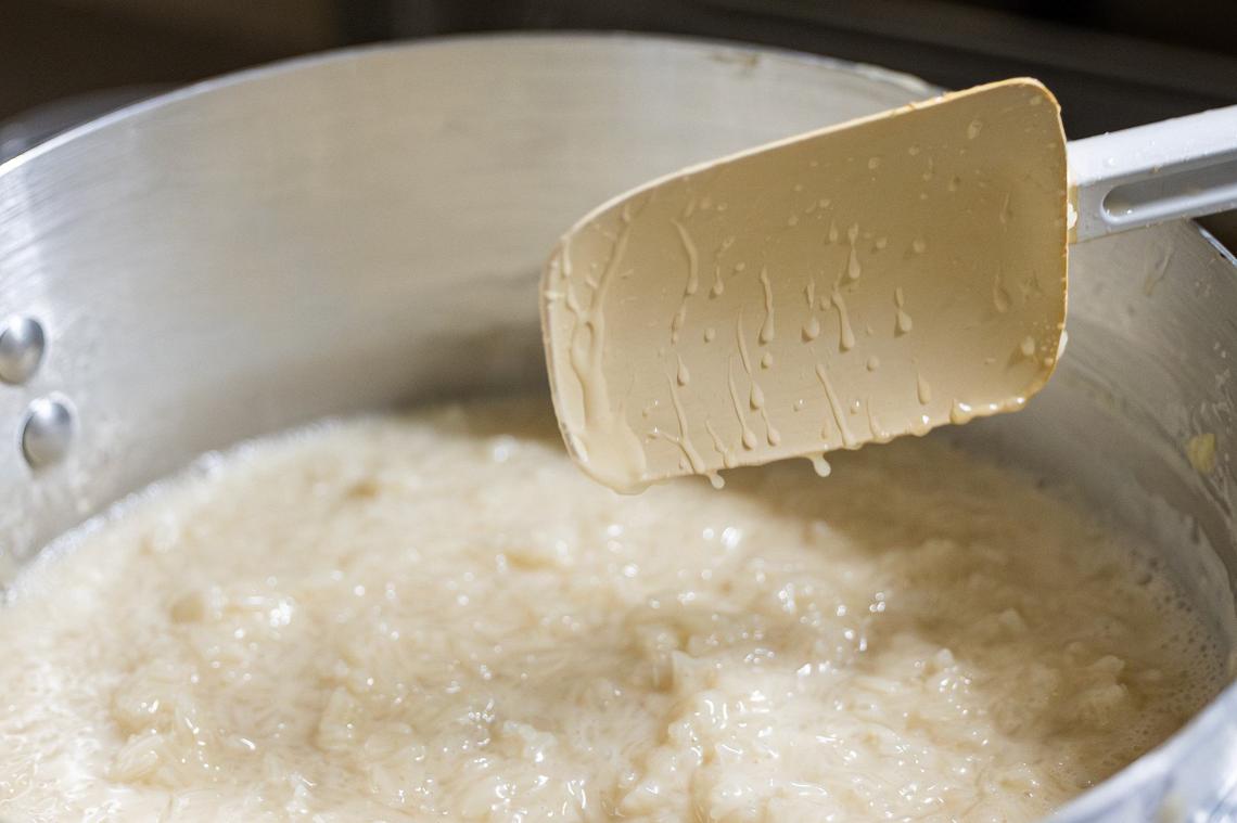 After the rice has cooked, it is mixed with a coconut cream sauce and put aside to rest before being portioned for the mango sticky rice dessert at Goldee’s Barbecue in Fort Worth on Friday, June 28, 2024.