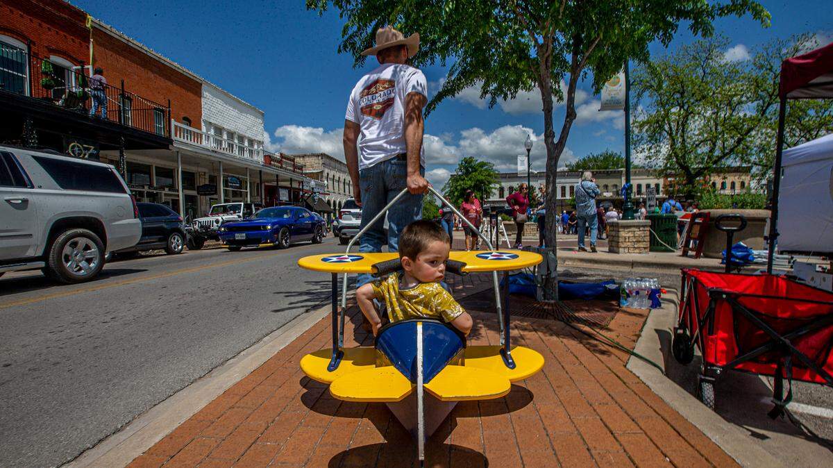 Frank Jaime pulling his son Bryson Reed around the Granbury Square during Wine Walk, a three-day festival featuring Texas wines, artists and musical acts. Photo taken Saturday, April 24, 2021.