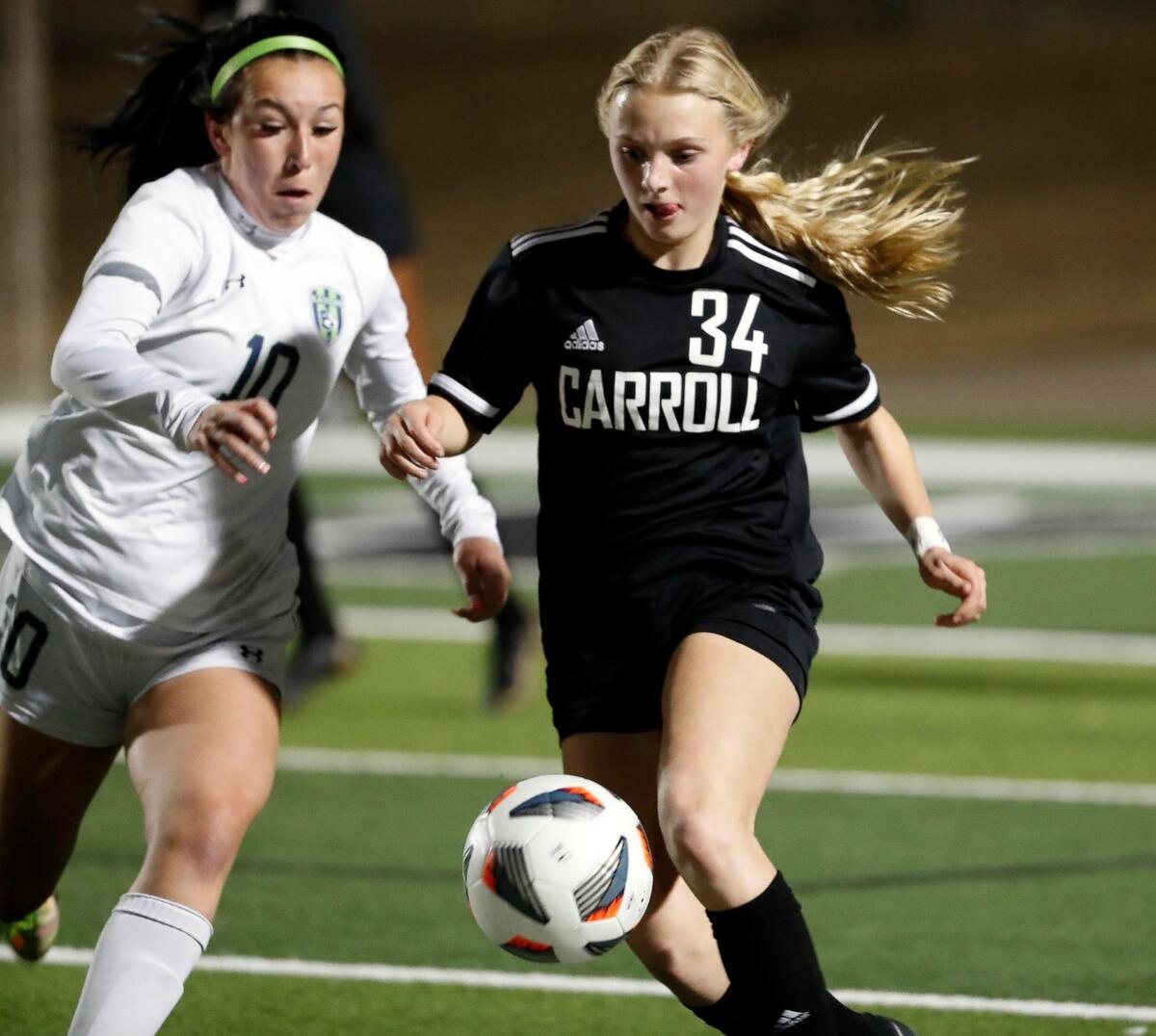 Carroll’s Hannah Jordan battles Eaton’s Madison Blue during a high school girls soccer game at Dragon Stadium in Southlake, Texas, Wednesday, Feb. 09, 2022. Carroll defeated Eaton 8-1. (Special to the Star-Telegram Bob Booth)