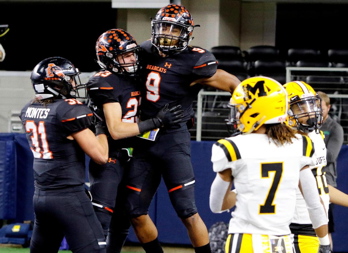 Aledo running back Jase McClellan (9) celebrates his touchdown with team mates Mylen Hayhurst (23) and Jordan Montes (31) in the first half of a Texas High School 5A Division II State Championship football game at AT&T Stadium, Arlington, Texas, Friday, Dec. 21, 2018. Aledo led 28-12 at the half. (Star-Telegram Bob Booth)