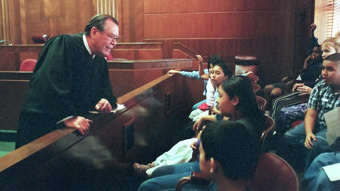 U.S. District Judge John McBryde of Fort Worth talks to students at Dezavala Elementary School, where he attended as a child, during a mock trial in his courtroom at the federal courthouse on Nov. 14, 2002.