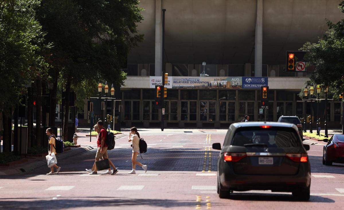 Pedestrians cross Commerce Street in downtown Fort Worth on Friday, July 29, 2022.