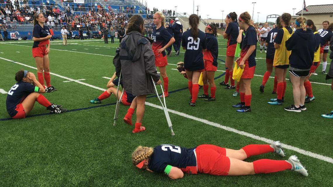 Louisiana Tech signee Sophia  Smith, foreground, and her Grapevine teammates gather near midfield after the Mustangs 4-3 shootout loss to Frisco Wakeland.